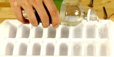 Pouring Vinegar in Ice Cube Tray